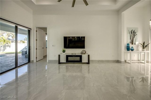 unfurnished living room with a towering ceiling and ceiling fan