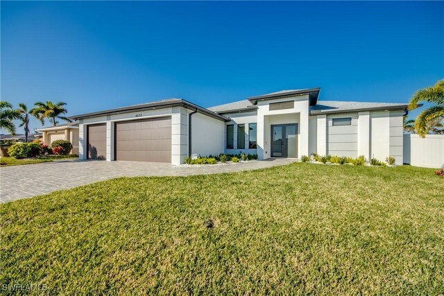 view of front of home featuring a garage and a front yard