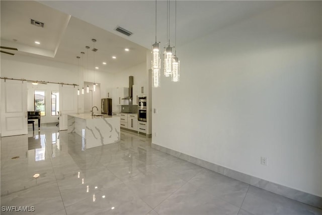 unfurnished dining area with sink and a barn door