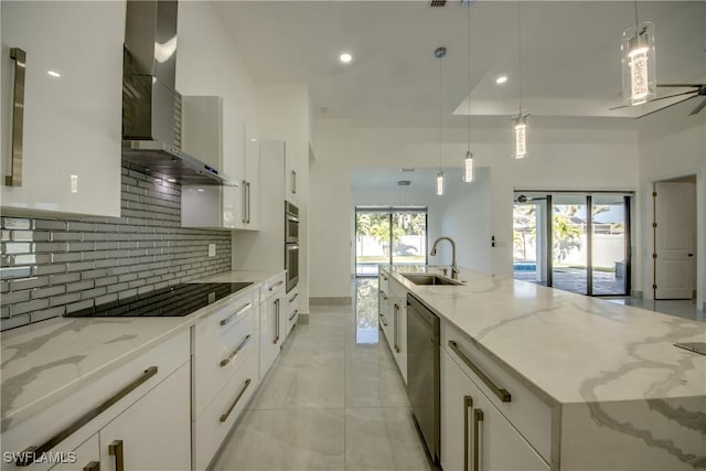 kitchen with white cabinetry, sink, and wall chimney exhaust hood