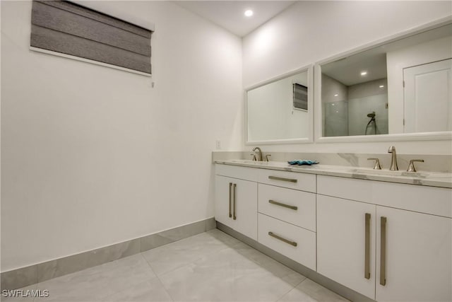 bathroom with vanity and a shower with shower door