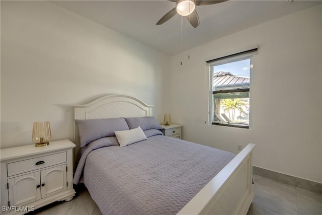 bedroom with light tile patterned floors and ceiling fan