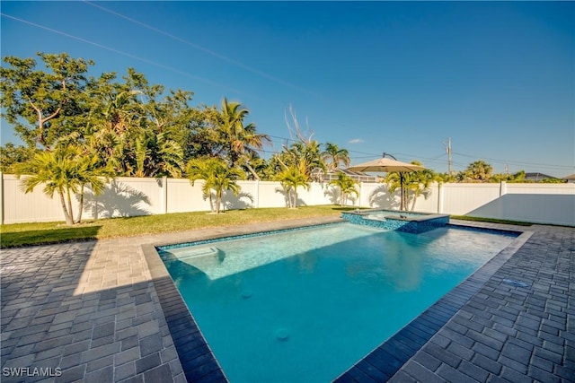 view of pool with a patio and an in ground hot tub