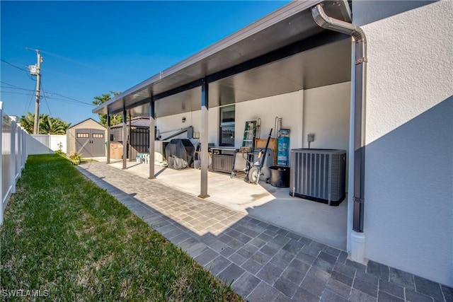 view of patio with cooling unit and a storage shed