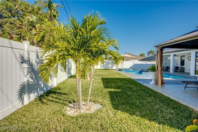 view of yard featuring a fenced in pool and a patio area