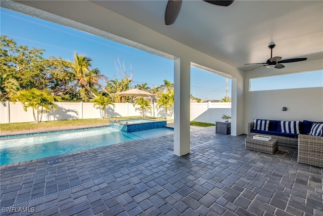 view of pool with an outdoor living space, a patio, an in ground hot tub, and ceiling fan