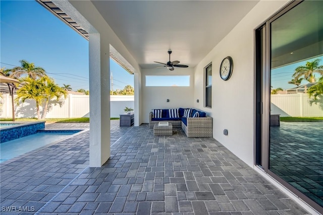 view of patio featuring ceiling fan, outdoor lounge area, and a fenced in pool