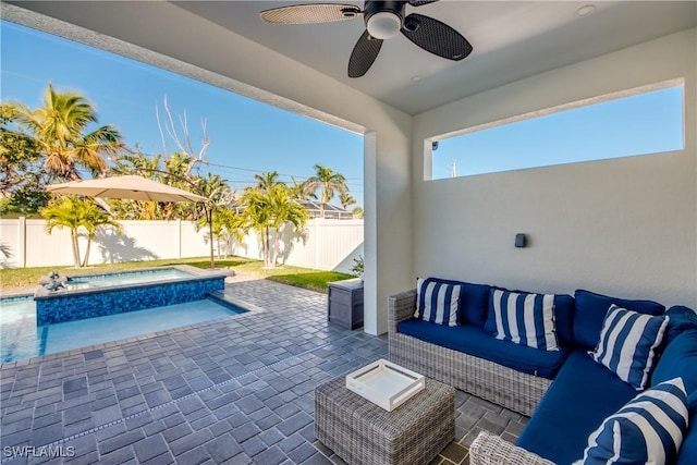 view of patio / terrace featuring an in ground hot tub, ceiling fan, and an outdoor living space