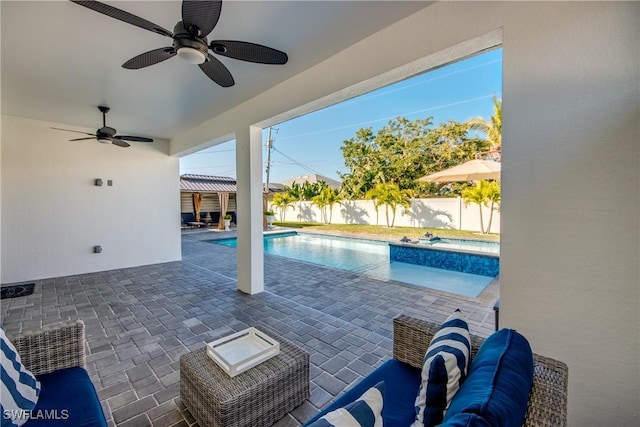 view of pool with ceiling fan and a patio area