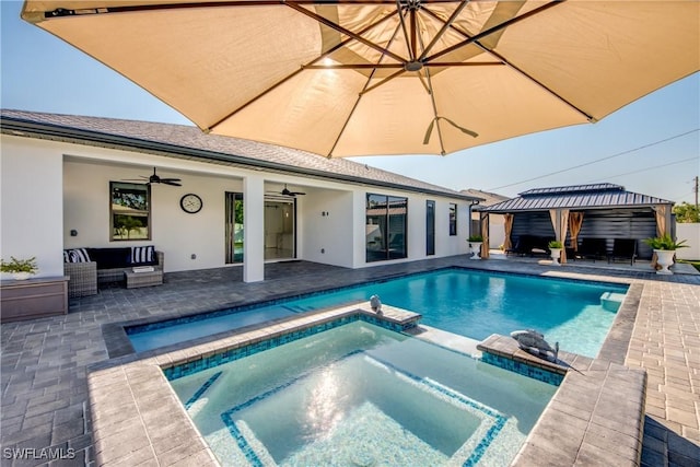 view of swimming pool featuring an outdoor living space, an in ground hot tub, a gazebo, and ceiling fan