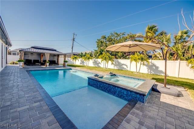 view of pool with a gazebo and an in ground hot tub