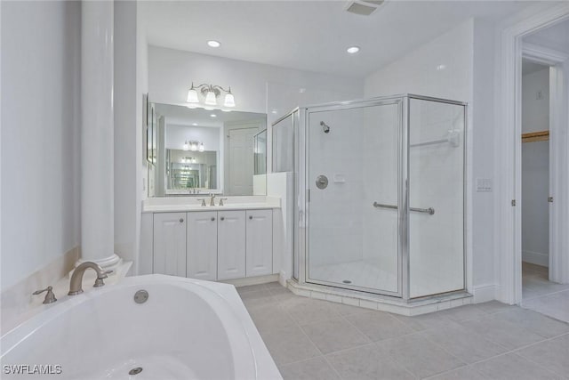 bathroom with tile patterned floors, separate shower and tub, and vanity