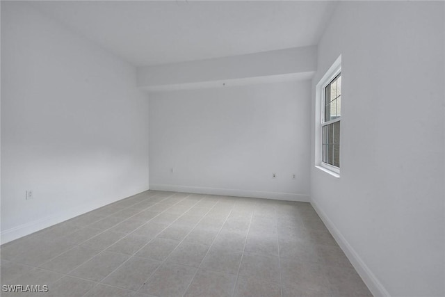 unfurnished room featuring light tile patterned floors