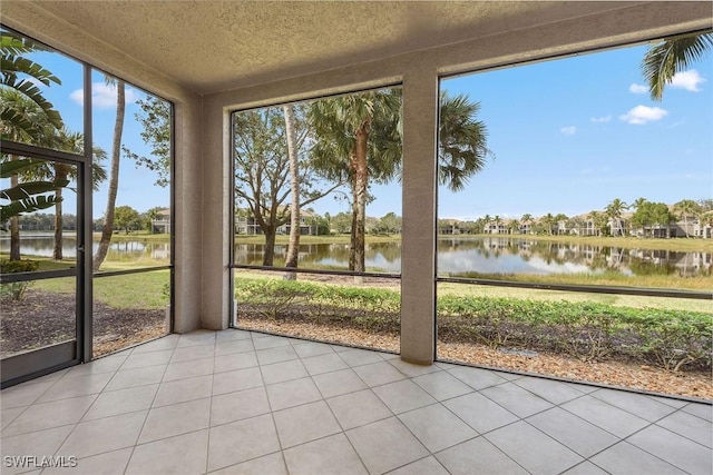 unfurnished sunroom with a water view