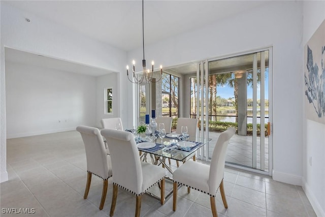 tiled dining area with a water view and a notable chandelier