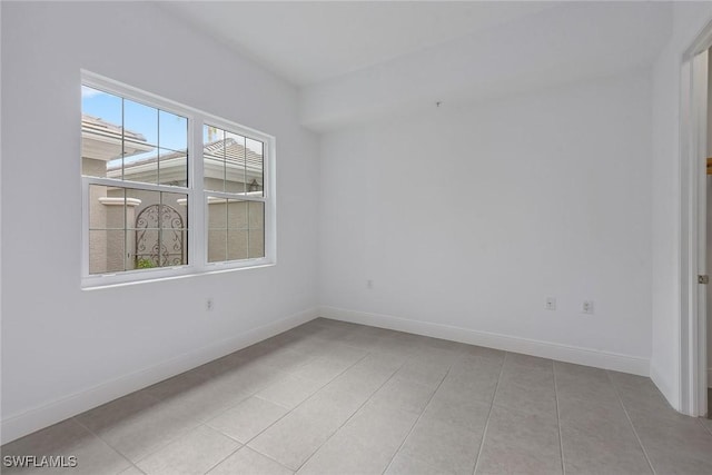 spare room with light tile patterned floors