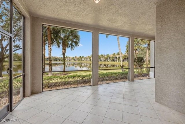 unfurnished sunroom with a water view