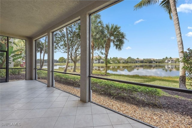 unfurnished sunroom featuring a water view