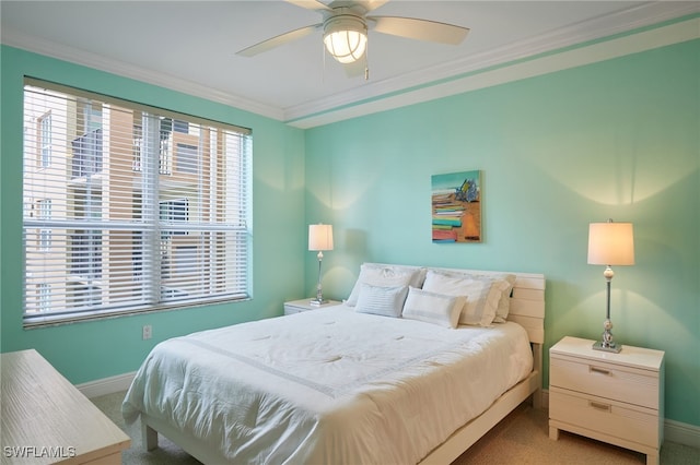 bedroom with ornamental molding, baseboards, a ceiling fan, and carpet