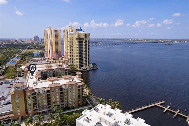 drone / aerial view featuring a city view and a water view