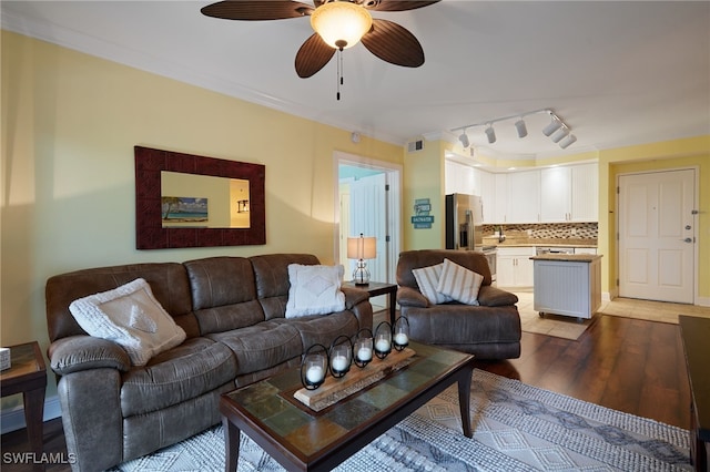 living area with crown molding, light wood-type flooring, a ceiling fan, and visible vents