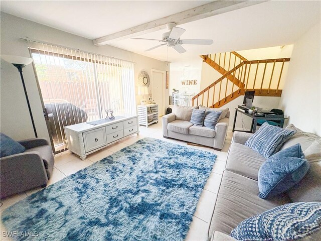 living room featuring ceiling fan, light tile patterned floors, and beam ceiling