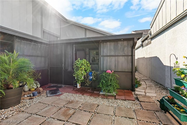 view of patio with a sunroom