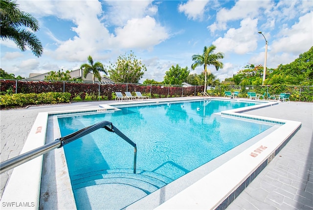 view of swimming pool with a patio area