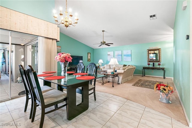 dining room with ceiling fan with notable chandelier, vaulted ceiling, and light tile patterned floors