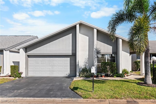 view of front of property featuring a garage and a front lawn