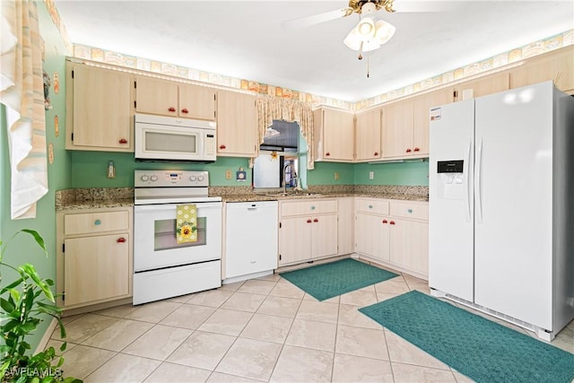 kitchen with sink, white appliances, light tile patterned floors, ceiling fan, and light stone countertops