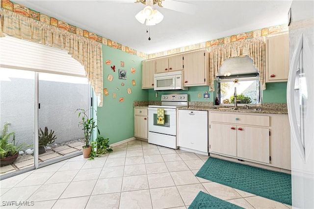 kitchen with sink, light stone counters, white appliances, light tile patterned floors, and ceiling fan