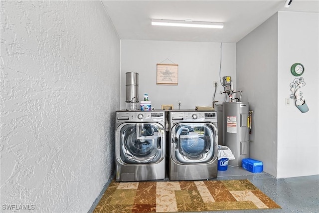 laundry room featuring washing machine and dryer and electric water heater