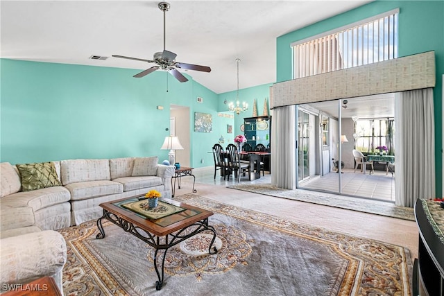 living room with ceiling fan with notable chandelier and high vaulted ceiling