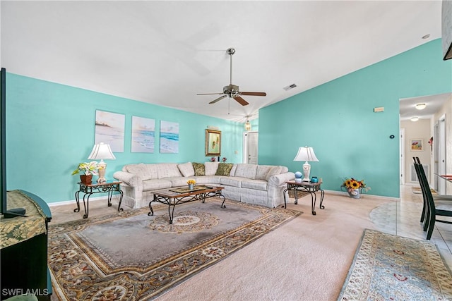 living room with ceiling fan, lofted ceiling, and carpet floors