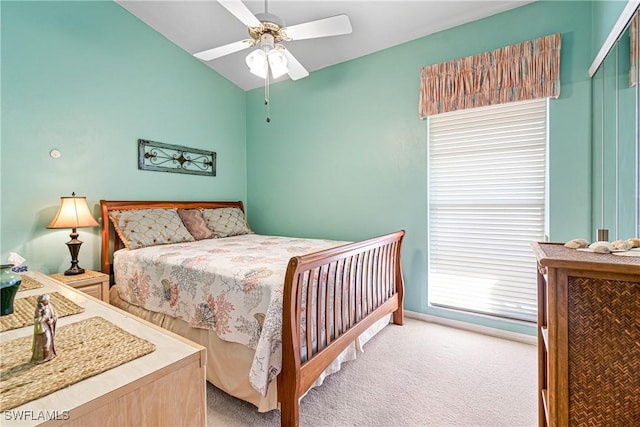 carpeted bedroom featuring lofted ceiling and ceiling fan