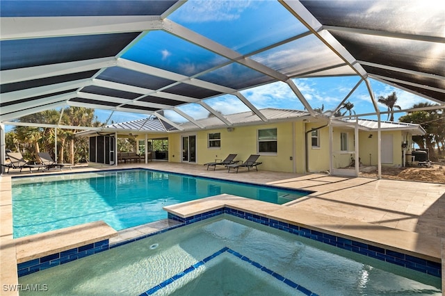 view of swimming pool featuring an in ground hot tub, a patio area, and glass enclosure