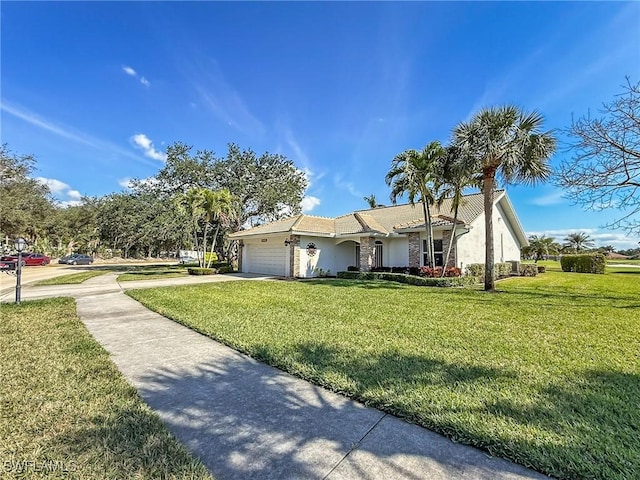 view of front of house featuring a front yard and a garage