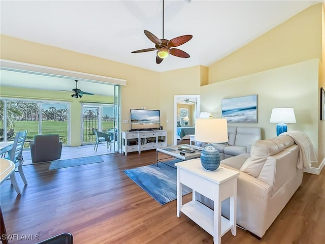 living room with ceiling fan, lofted ceiling, and dark hardwood / wood-style flooring