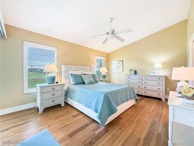 bedroom featuring ceiling fan, light hardwood / wood-style floors, and vaulted ceiling