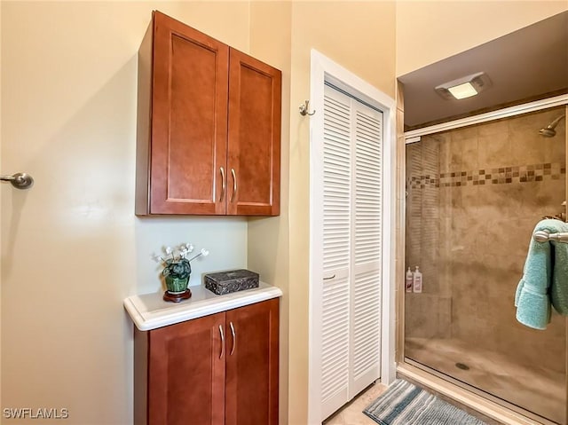 bathroom with a shower with door