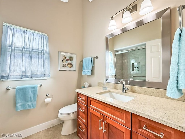 bathroom featuring toilet, a shower with shower door, vanity, a healthy amount of sunlight, and tile patterned flooring