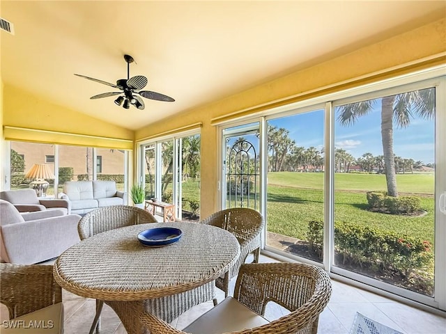 sunroom / solarium featuring lofted ceiling and ceiling fan