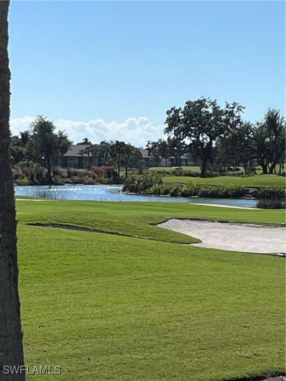 view of community with a water view and a lawn