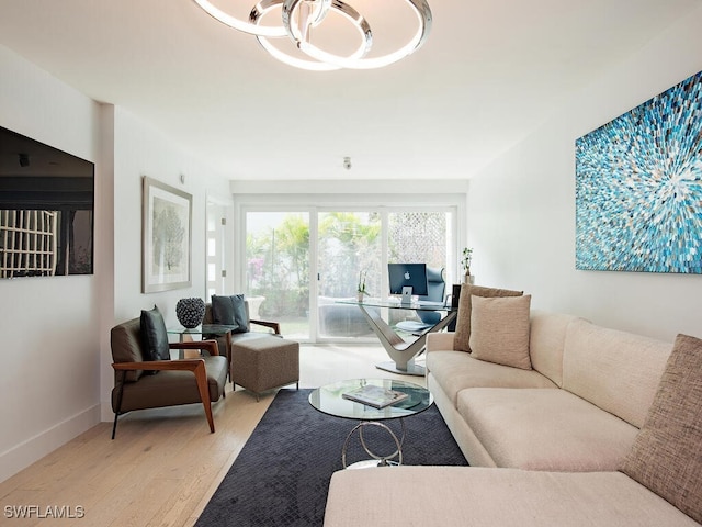 living area featuring baseboards and light wood-style floors