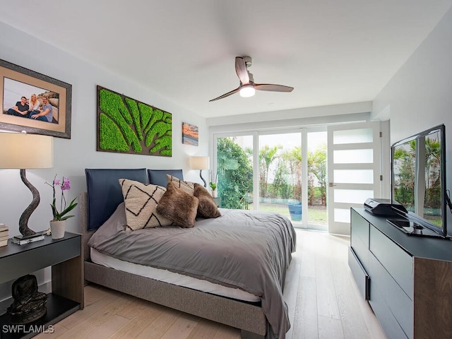 bedroom featuring access to exterior, light wood finished floors, and a ceiling fan