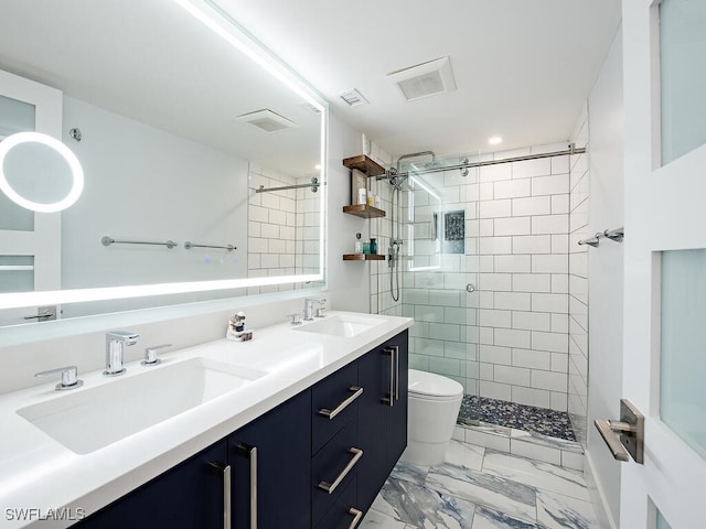 full bathroom featuring marble finish floor, a sink, toilet, and a shower stall