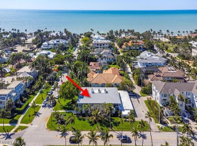 drone / aerial view featuring a residential view and a water view