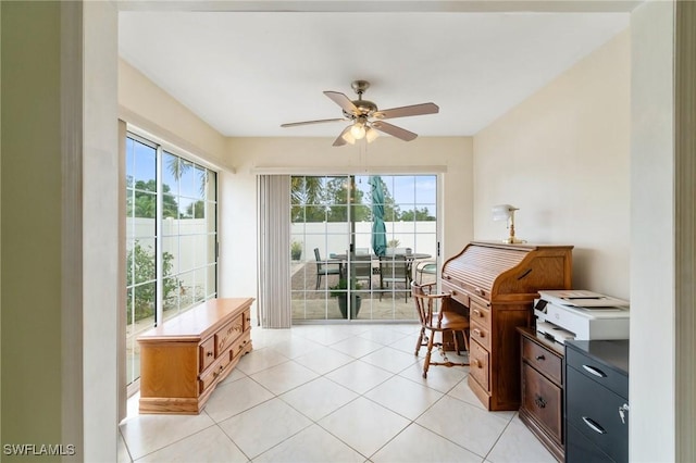 office with a healthy amount of sunlight, ceiling fan, and light tile patterned floors