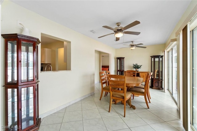 dining space with light tile patterned floors, visible vents, and baseboards